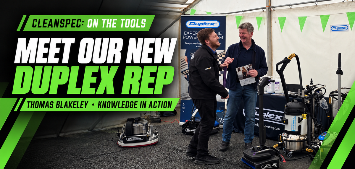 Thomas Blakeley from Duplex Cleaning Machines speaking with visitors beside professional cleaning equipment at the Cleanspec Open Day.